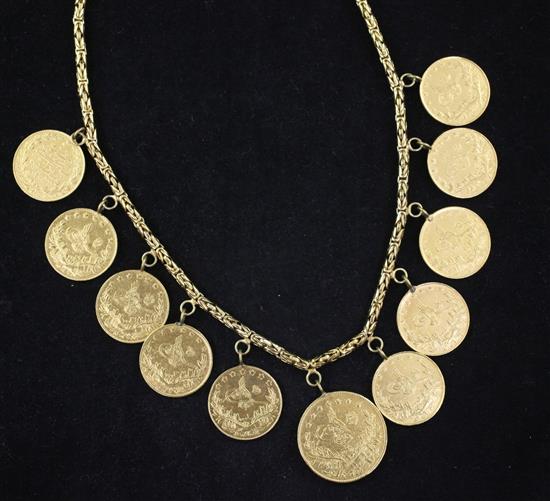 A 14ct gold necklace hung with ten Turkish 100 piastres gold coins and one 250 piastres gold coin.